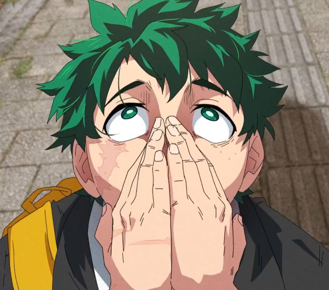 Izuku Midoriya from My Hero Academia pressing his hands together over his face, looking up hopefully